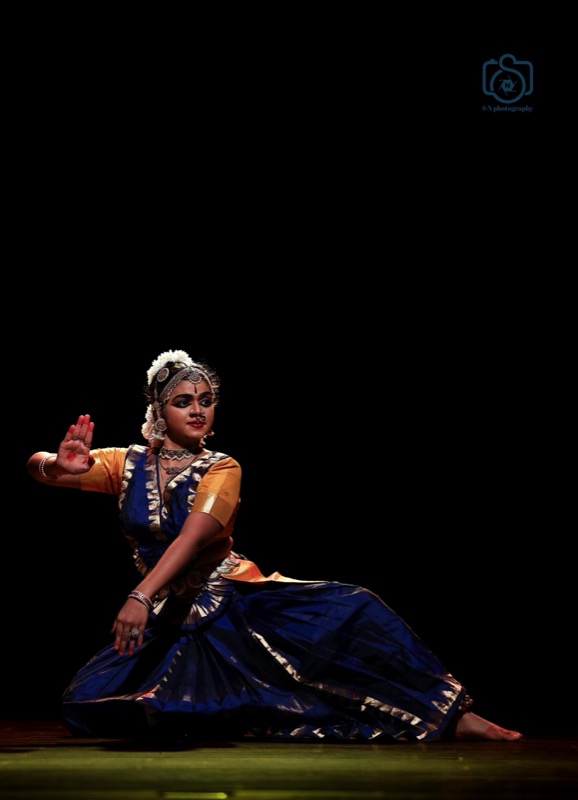 Dancer in blue silk with a raised hand