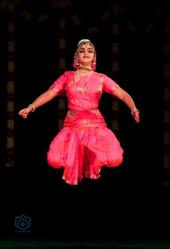 Dancer in pink caught mid-leap