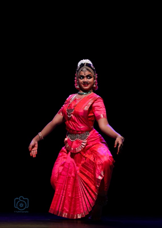 Dancer in pink silk glancing over her shoulder