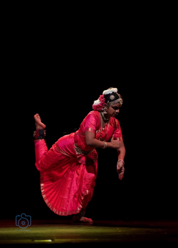 Dancer balancing on one leg in a pink costume