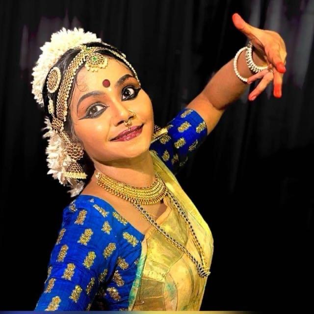 Close portrait of a dancer in blue and gold